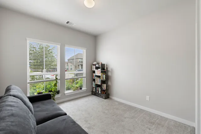 a bathroom with a bathtub shower sink vanity mirror and toilet