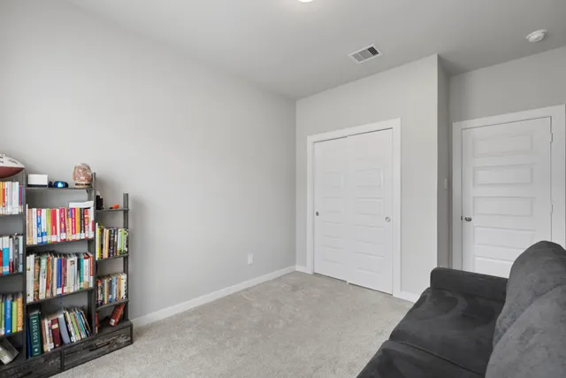 a bedroom with two beds and a chandelier