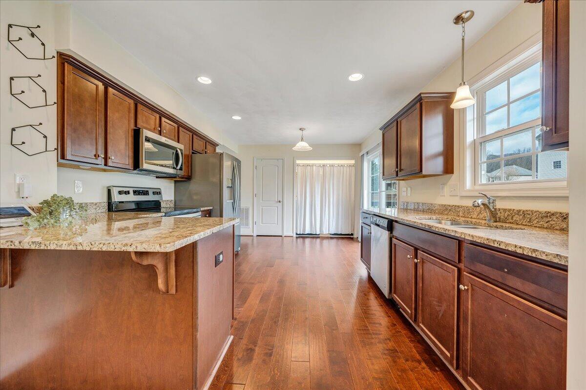 427 Cambridge Ct Road Vinton, VA 24179 - Photo 15 of 46 a kitchen with stainless steel appliances granite countertop a stove and cabinets
