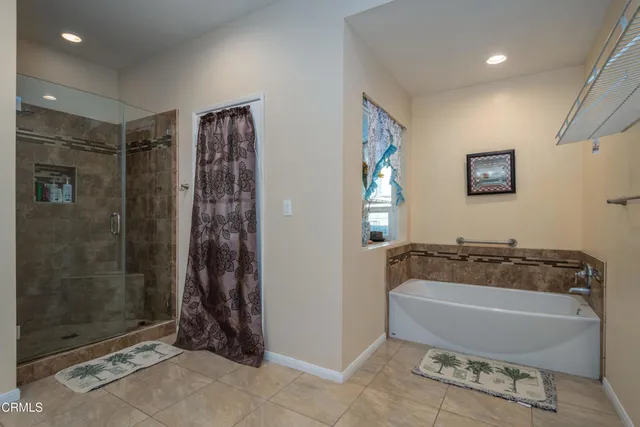 a bathroom with a bathtub and shower