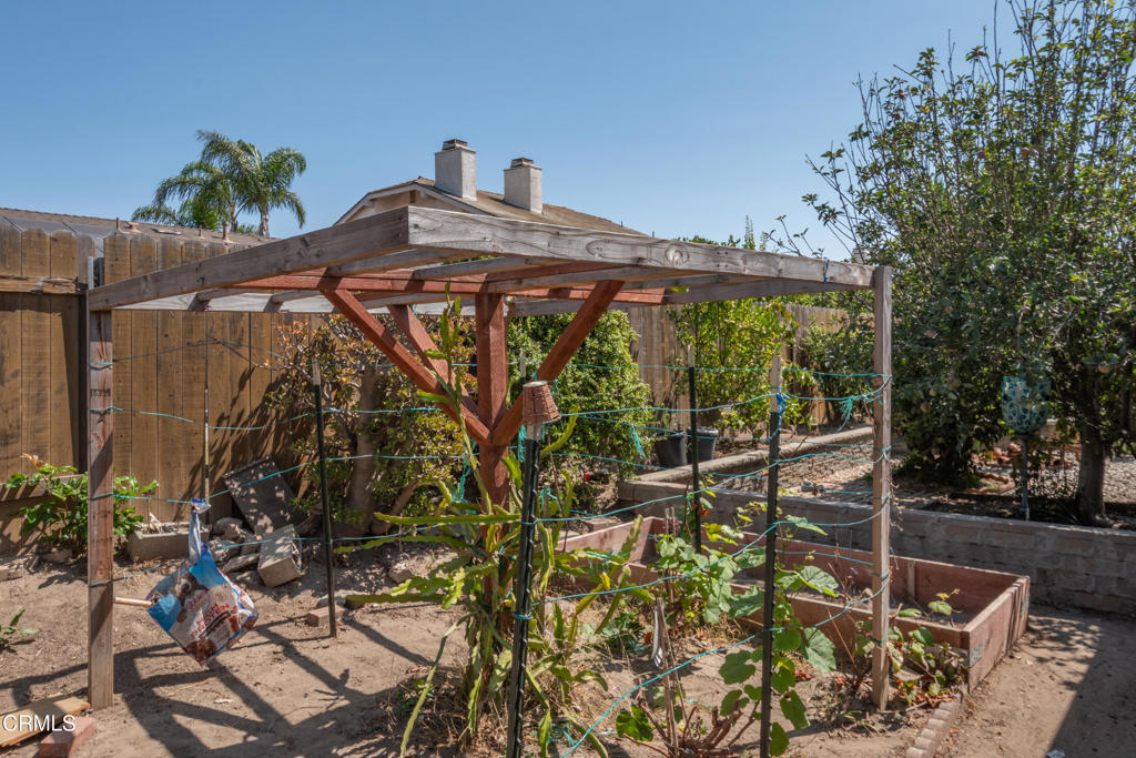 670 Joliet Place Oxnard, CA 93030 - Photo 30 of 33 a view of a backyard with table and chairs and potted plants