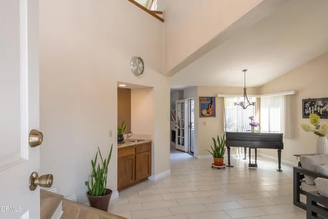 a view of a livingroom with furniture window and kitchen view