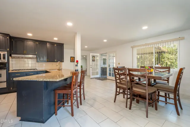 a dining table with chairs and window