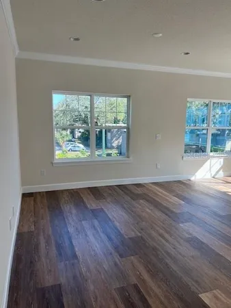 wooden floor in an empty room with a window