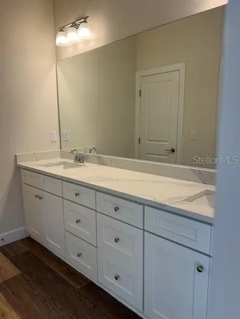 a bathroom with a sink and mirror
