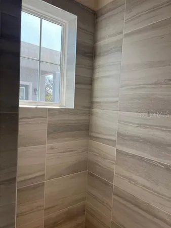 a bathroom with a glass shower door