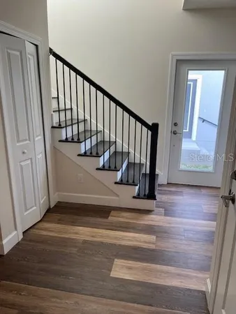 a view of entryway with wooden floor and stairs