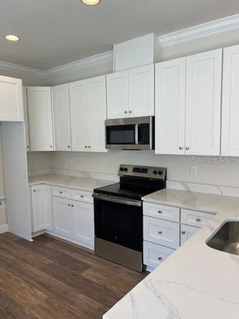a kitchen with stainless steel appliances granite countertop a stove and a sink