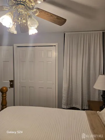 a bed room with a bed and a chandelier
