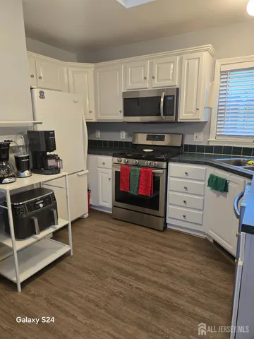 a kitchen with stainless steel appliances granite countertop a stove and a microwave