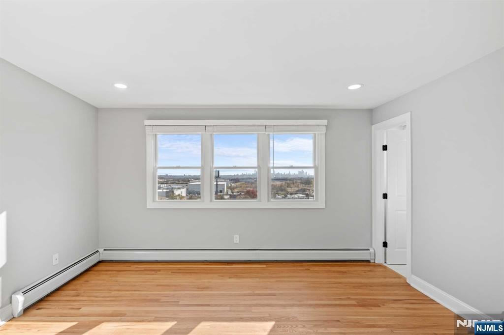 743 7th Street, Unit 1 Carlstadt, NJ 07072 - Photo 13 of 23 a view of an empty room with a window and wooden floor