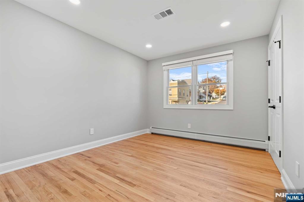 743 7th Street, Unit 1 Carlstadt, NJ 07072 - Photo 16 of 23 a view of empty room with wooden floor and fan