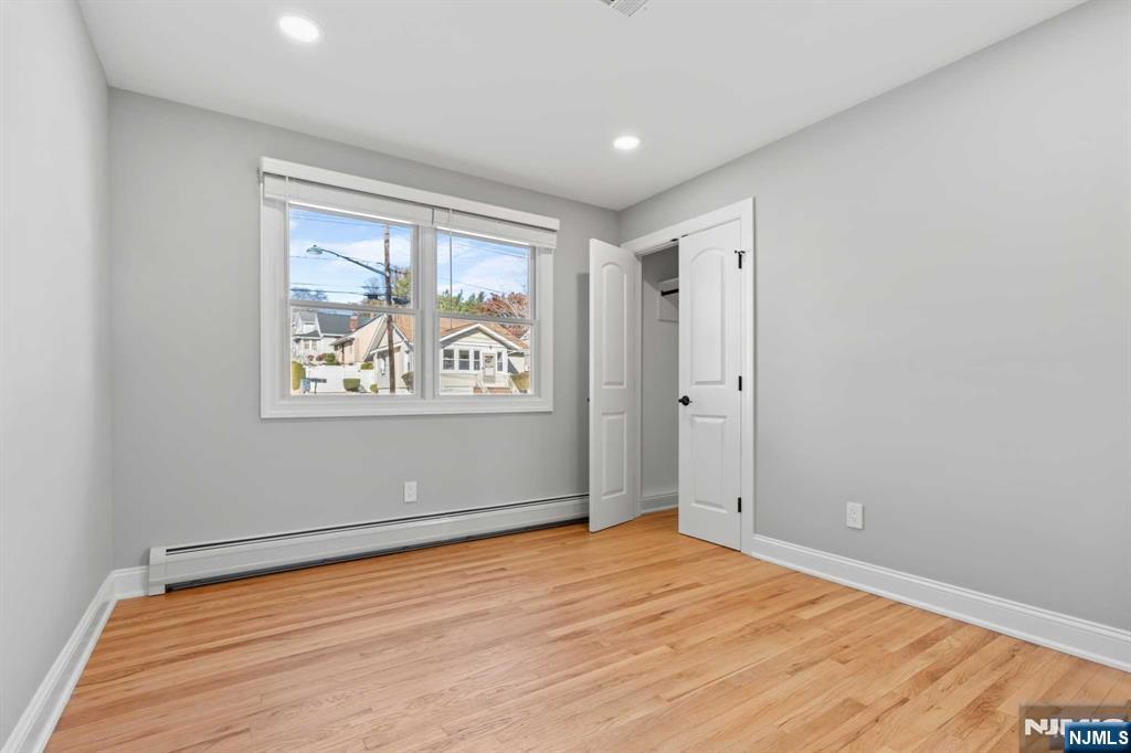 743 7th Street, Unit 1 Carlstadt, NJ 07072 - Photo 17 of 23 an empty room with wooden floor and window