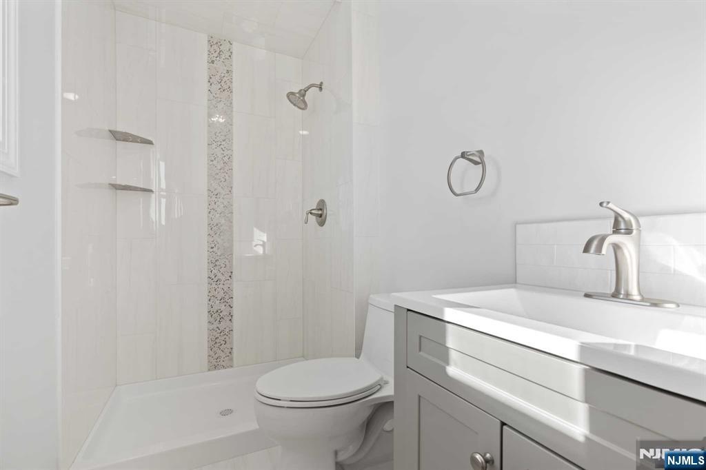 743 7th Street, Unit 1 Carlstadt, NJ 07072 - Photo 20 of 23 a bathroom with a sink a toilet and shower
