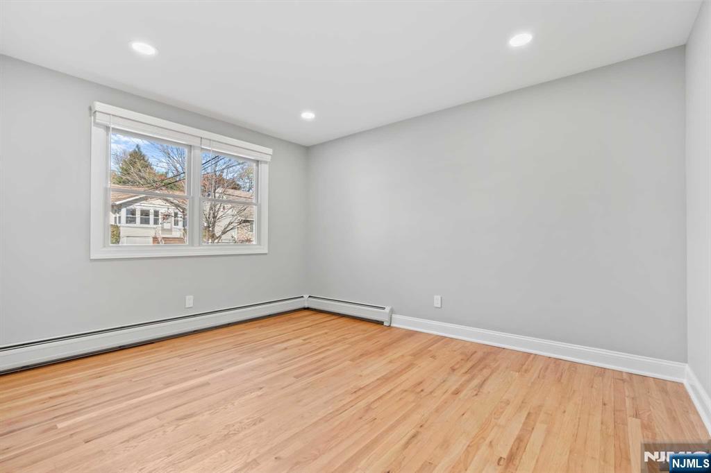743 7th Street, Unit 1 Carlstadt, NJ 07072 - Photo 9 of 23 a view of empty room with wooden floor and fan