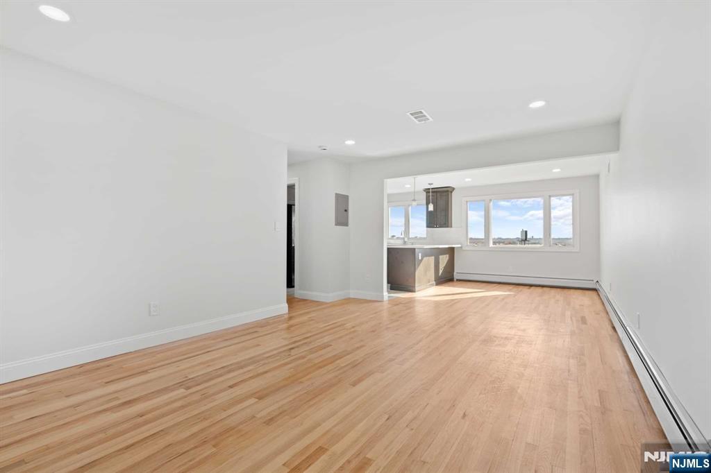 743 7th Street, Unit 1 Carlstadt, NJ 07072 - Photo 10 of 23 wooden floor in an empty room with a window