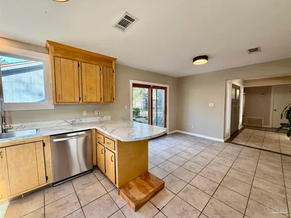 a kitchen with stainless steel appliances granite countertop a sink and cabinets