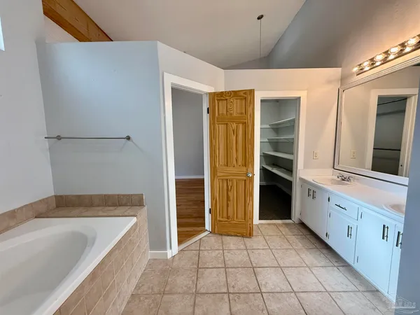 a bathroom with a granite countertop sink and mirror