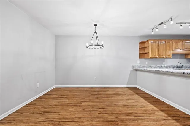 a view of a kitchen with wooden floor and a sink