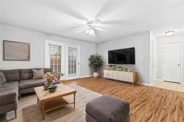 a bedroom with a bed a flat screen tv and a couch