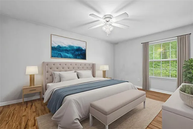 a bedroom with a large bed and a chandelier