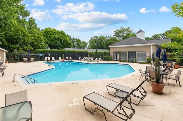 a view of a swimming pool with lounge chairs