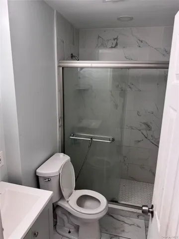 a bathroom with a toilet and a shower