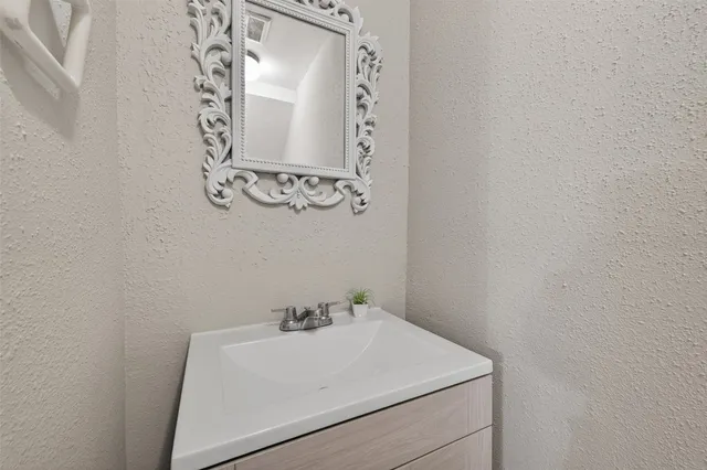 a bathroom with a sink and vanity