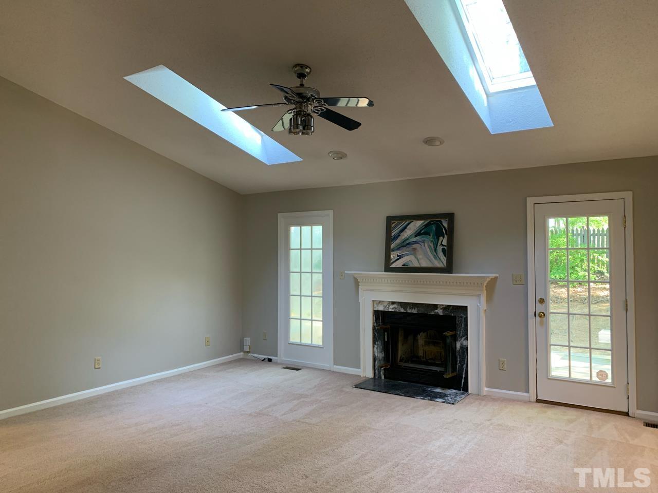 5208 Wallingford Drive Raleigh, NC 27616 - Photo 3 of 15 a view of an empty room with window and fireplace