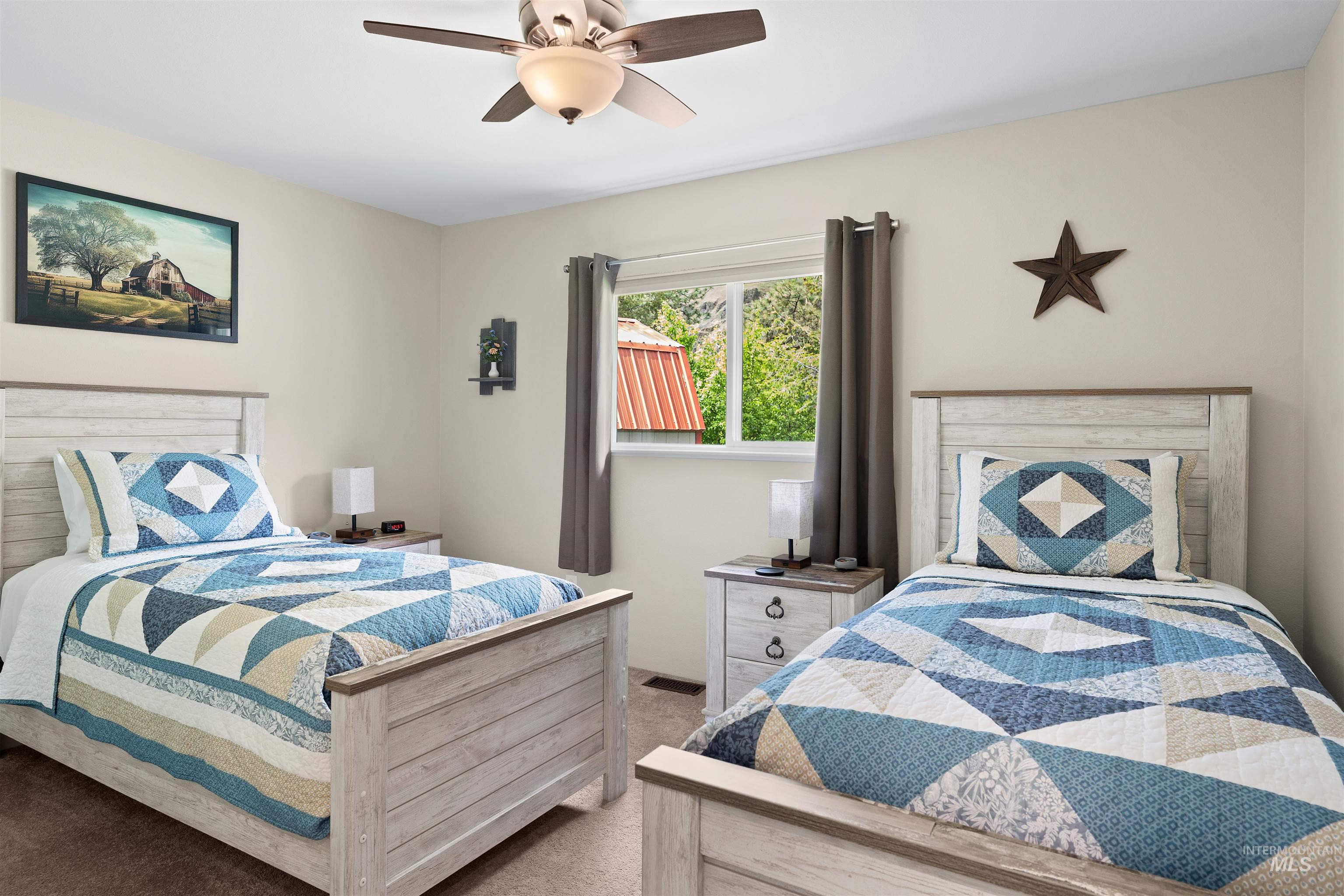 20015 Clark Street Juliaetta, ID 83535 - Photo 19 of 46 Neutral-toned bedroom featuring a ceiling fan with integrated lighting