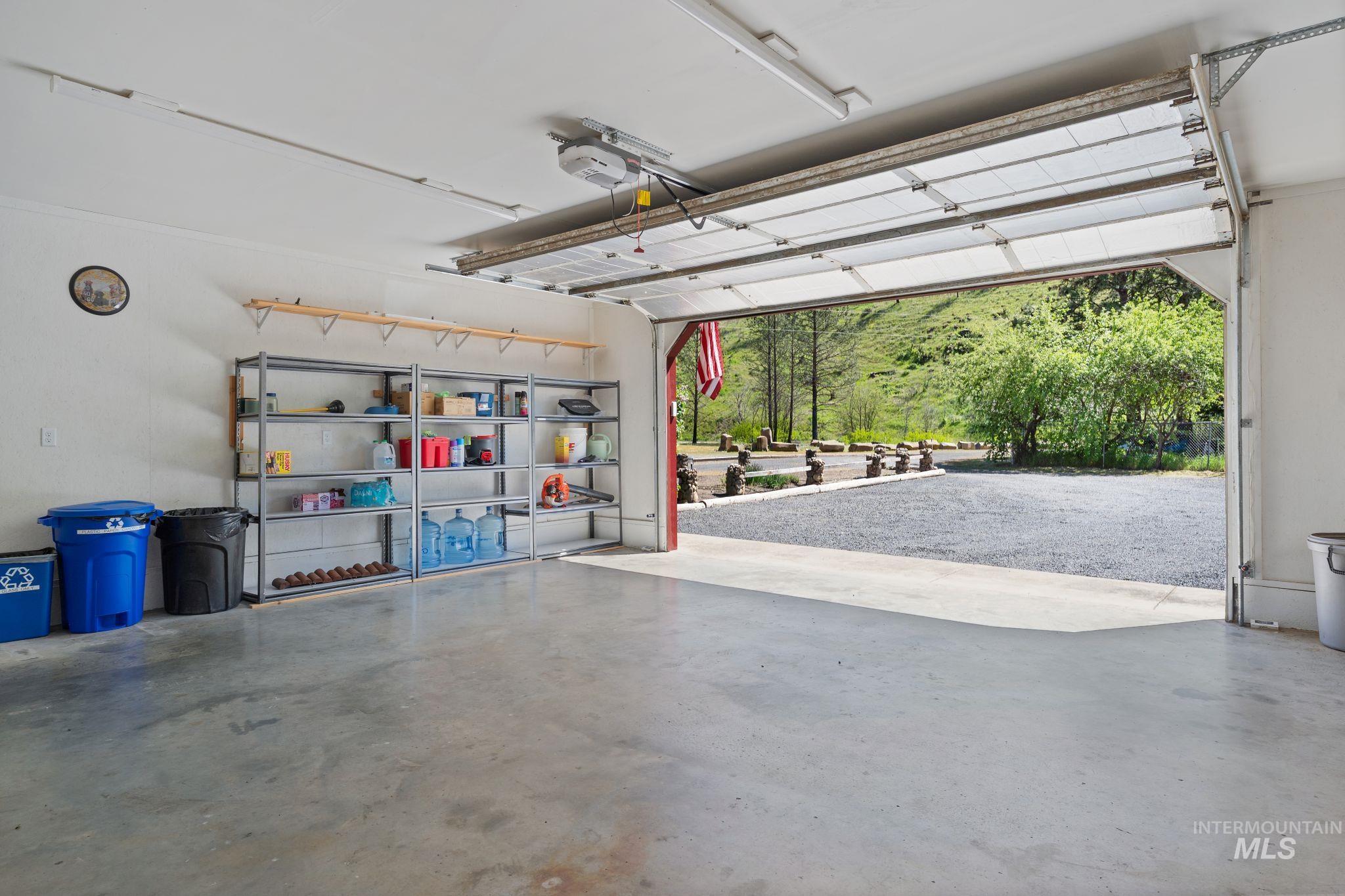 20015 Clark Street Juliaetta, ID 83535 - Photo 29 of 46 Spacious garage with a concrete floor, overhead lighting, and built-in shelving units