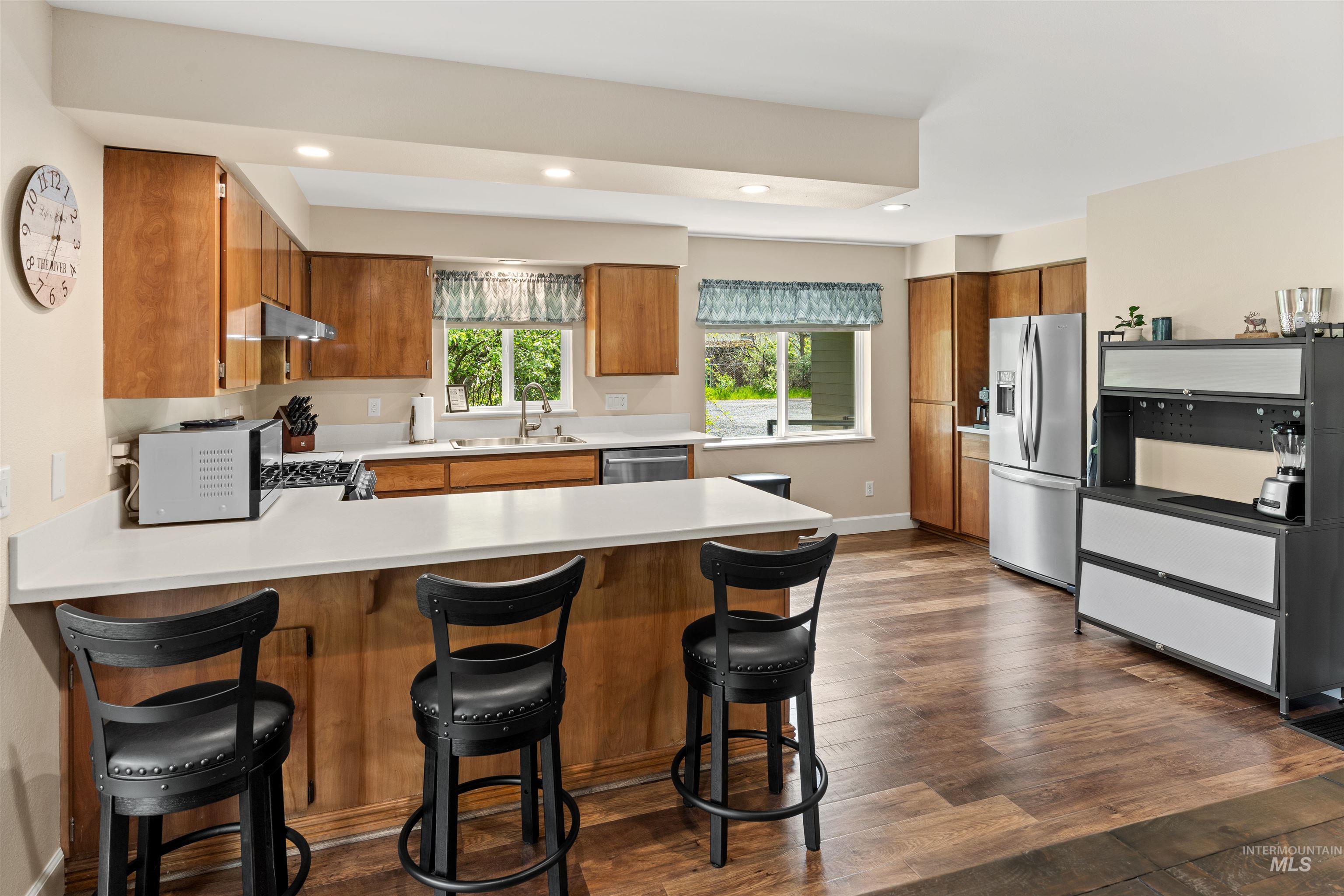 20015 Clark Street Juliaetta, ID 83535 - Photo 32 of 46 Contemporary kitchen featuring wood-finish flooring and light-toned cabinetry