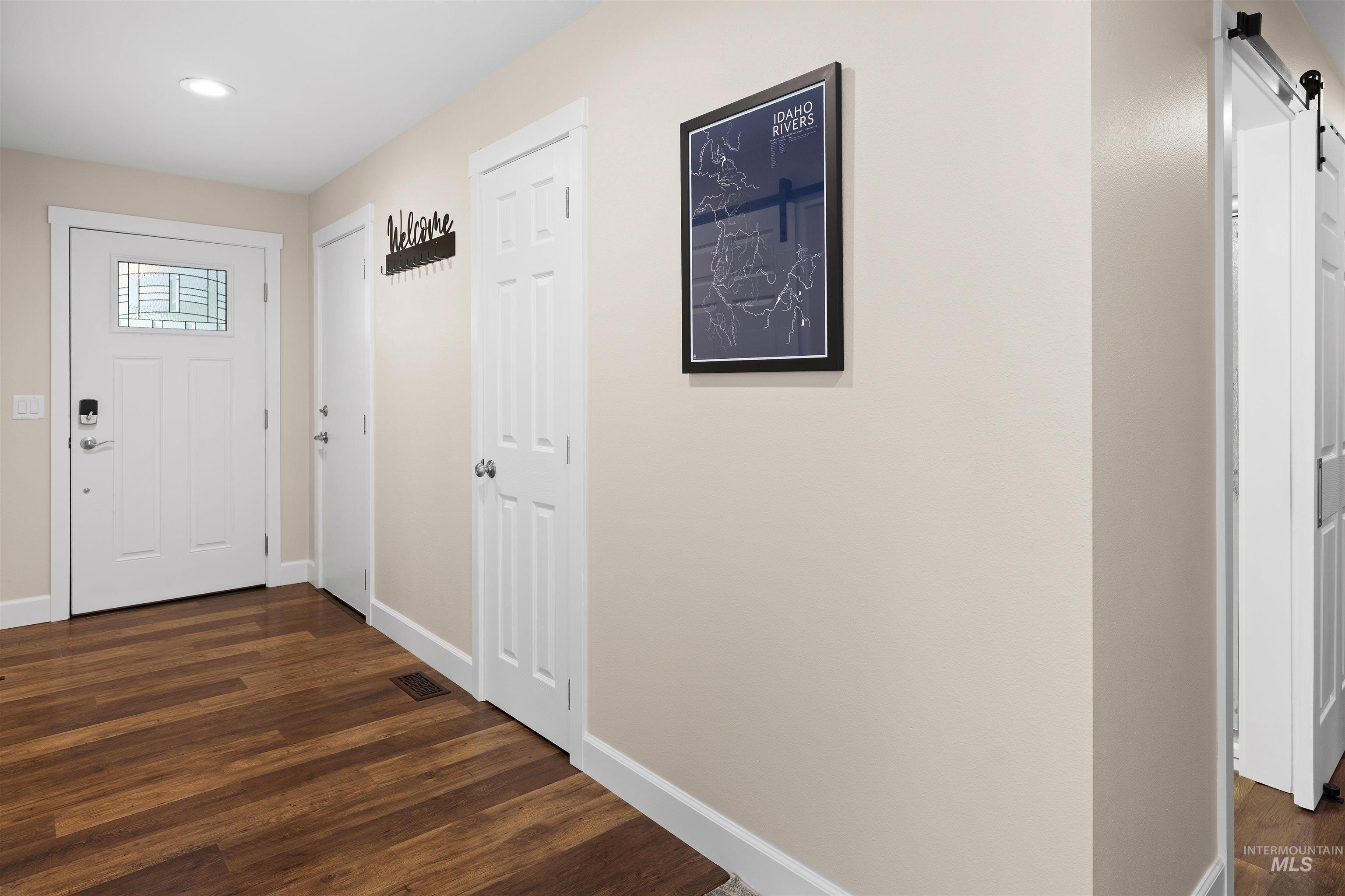 20015 Clark Street Juliaetta, ID 83535 - Photo 33 of 46 Entryway featuring wood-finish flooring, white baseboards, and neutral wall tones