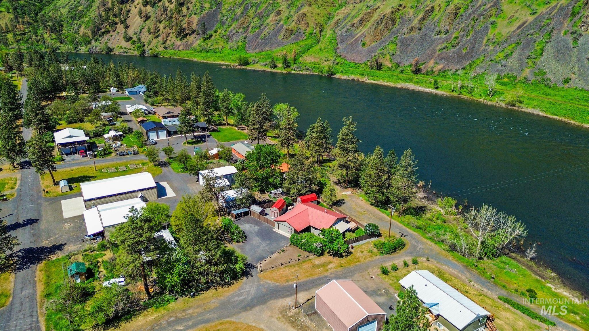 20015 Clark Street Juliaetta, ID 83535 - Photo 34 of 46 Riverfront community with multiple structures, mature trees, a paved road network, and a prominent river backdrop