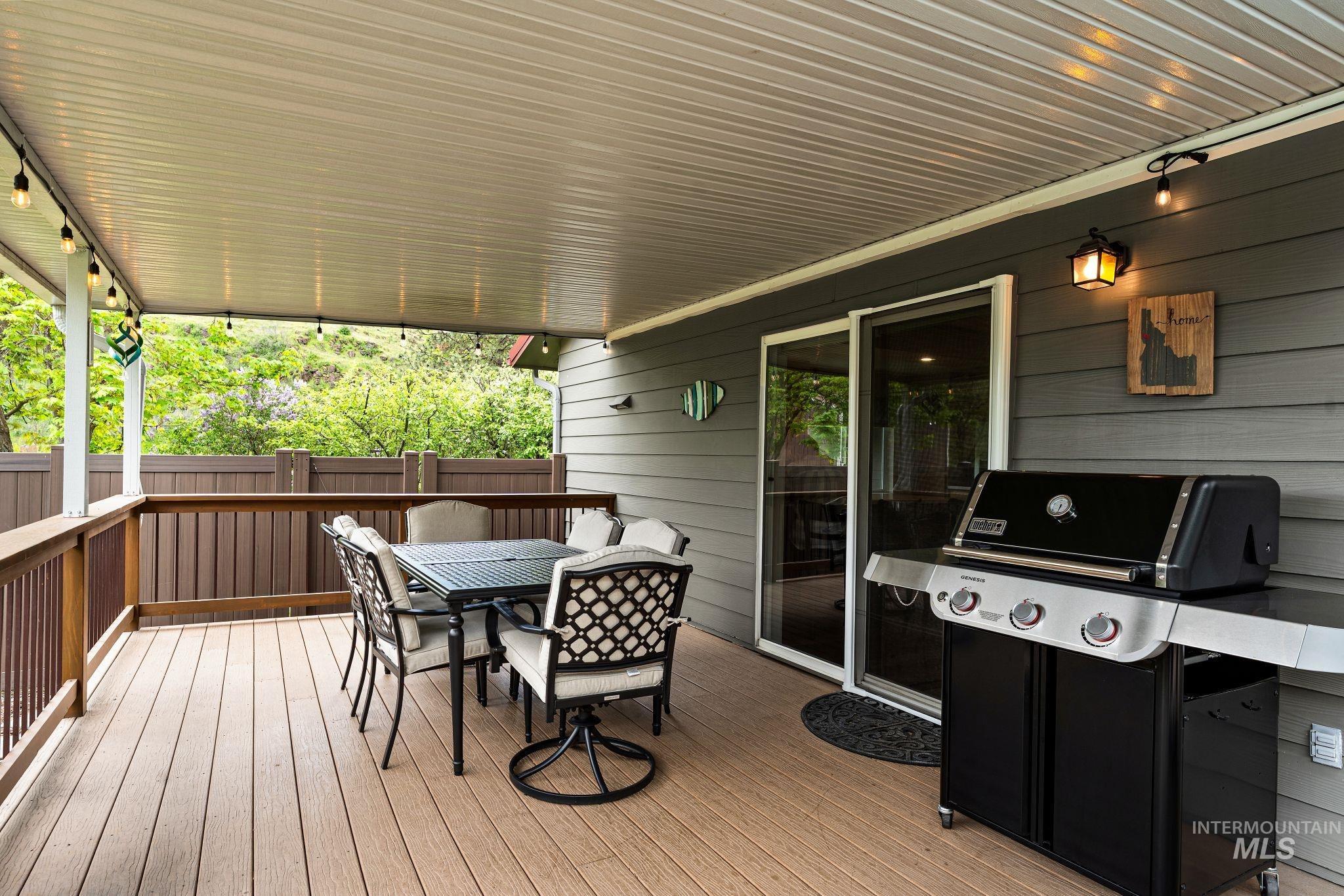 20015 Clark Street Juliaetta, ID 83535 - Photo 38 of 46 Covered outdoor deck featuring composite decking and a durable privacy fence