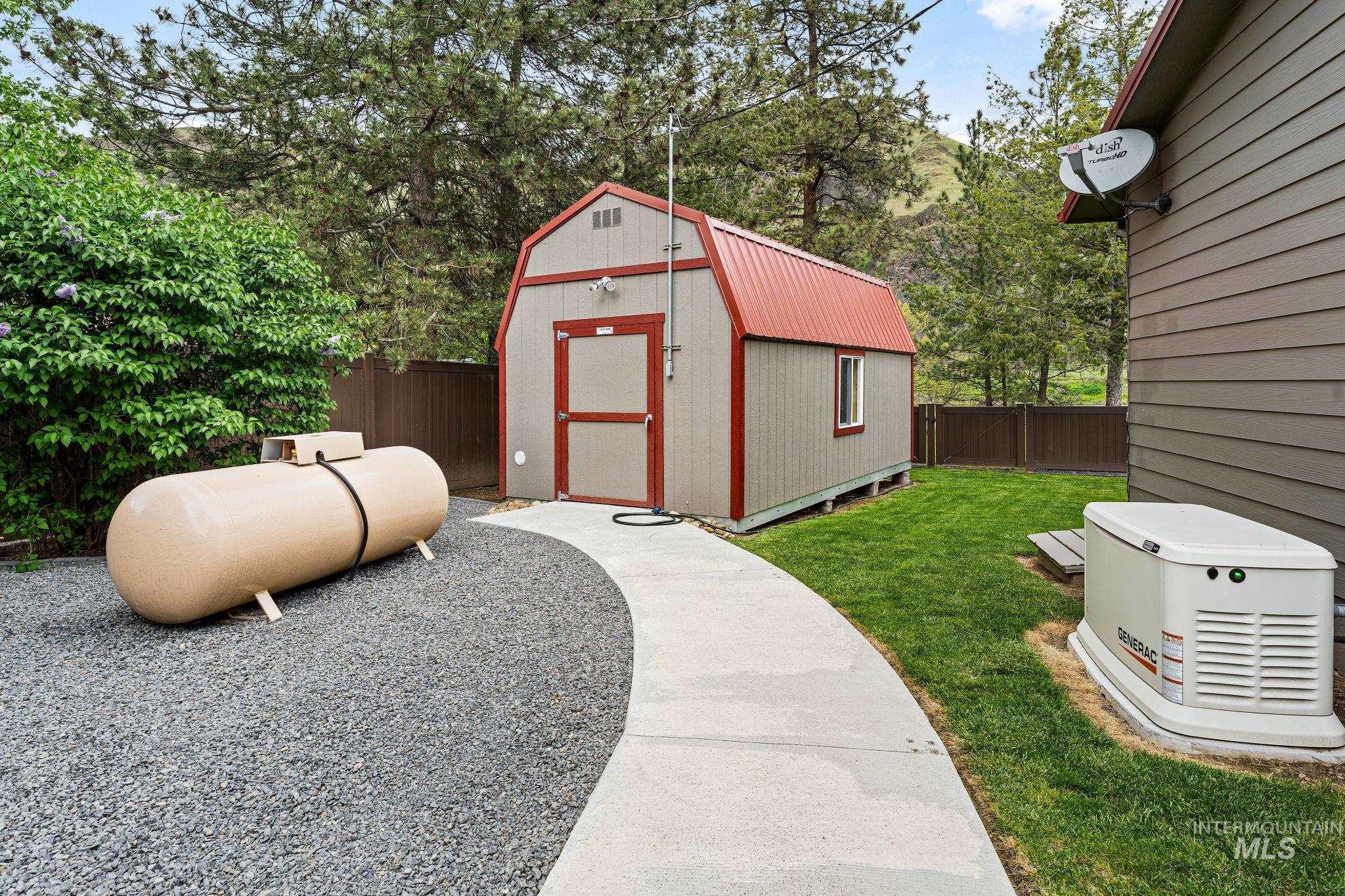 20015 Clark Street Juliaetta, ID 83535 - Photo 44 of 46 Detached storage shed with a gambrel roof and a concrete pathway