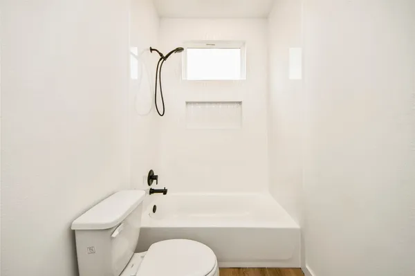 a bathroom with a toilet and a bathtub