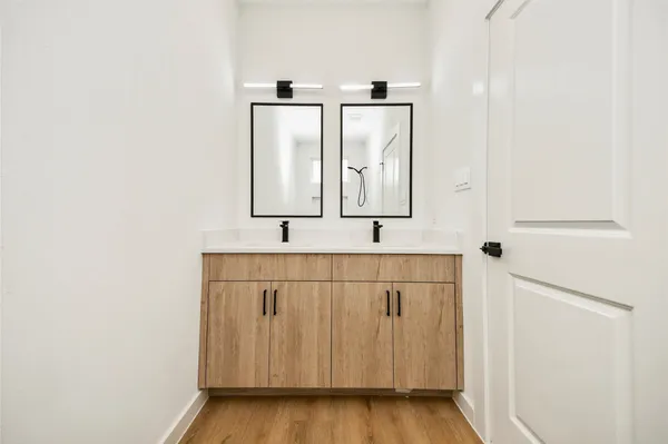 a bathroom with a sink a mirror and shower