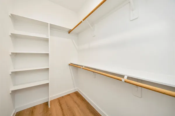 a view of walk in closet with empty racks