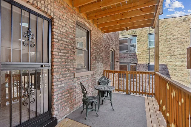a view of a balcony with furniture