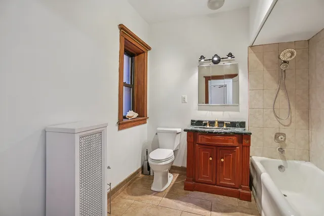 a bathroom with a toilet sink and mirror