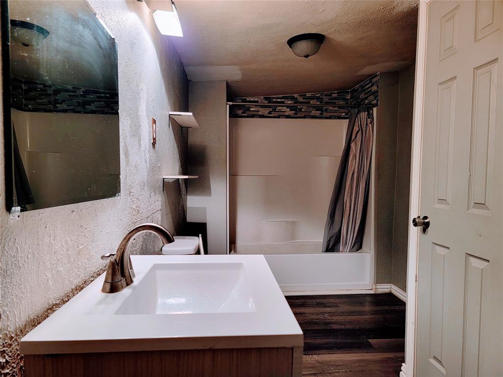 2004 Prairie Avenue Fort Worth, TX 76164 - Photo 14 of 21 a bathroom with a sink and a mirror