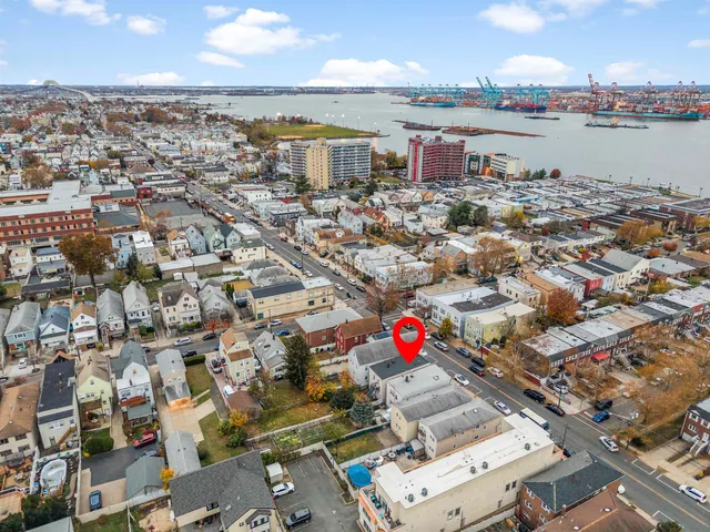 an aerial view of residential houses with city view