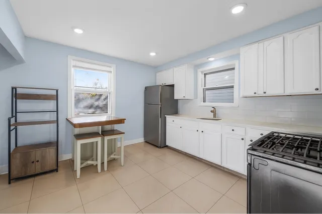 a kitchen with granite countertop cabinets and window