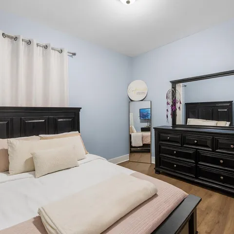 a bedroom with a bed and a tv