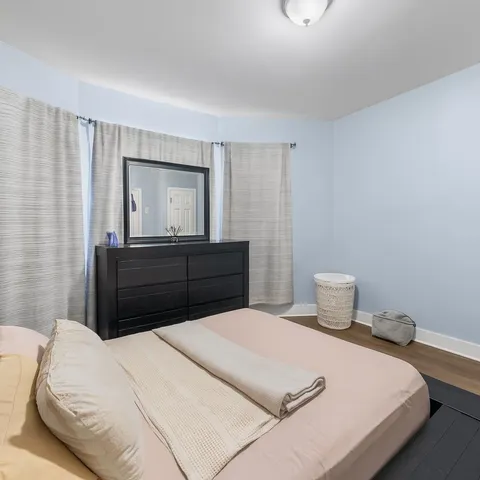 a bedroom with a bed and a mirror