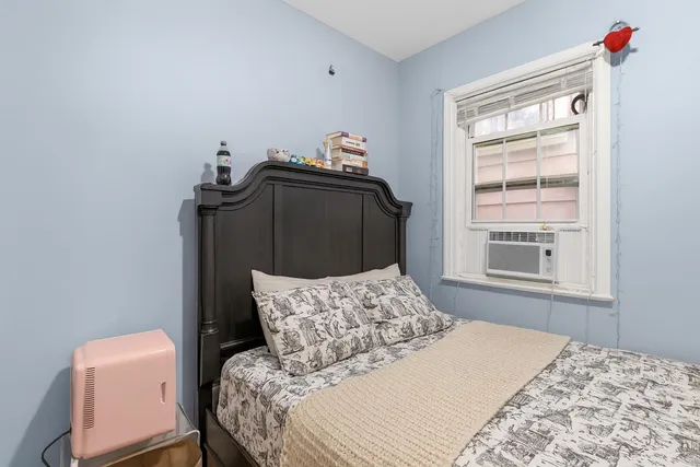 a bedroom with a bed and a window