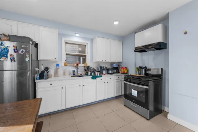 a kitchen with a sink cabinets and stainless steel appliances