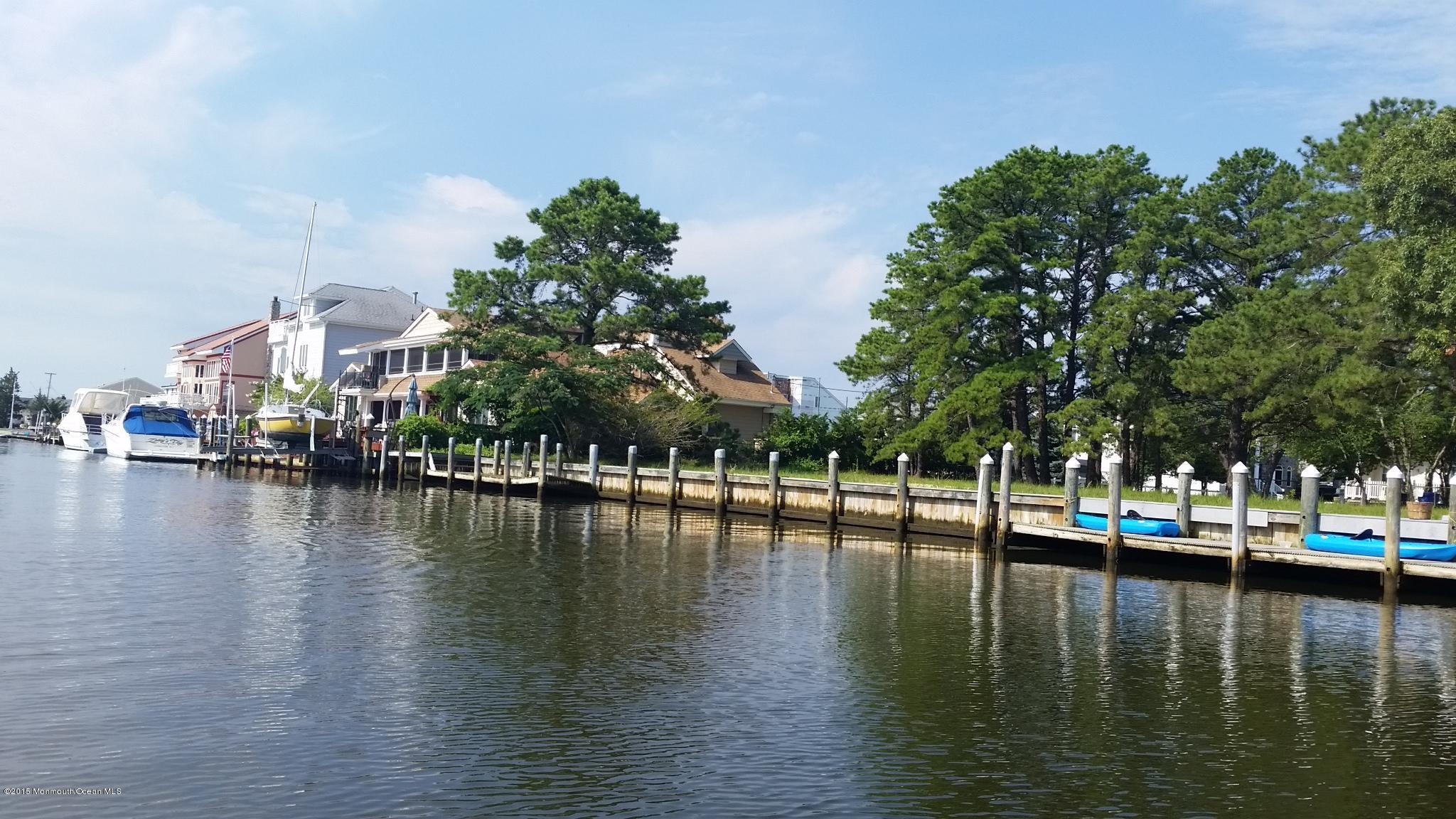 104 Mermaid Road Toms River, NJ 08753 - Photo 4 of 4 a view of a lake with boats and trees in the background