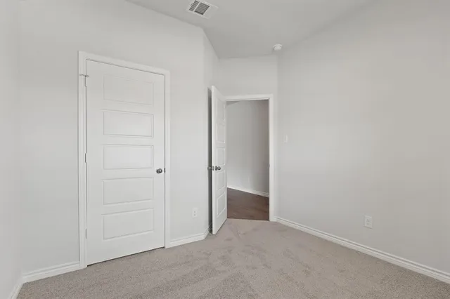an empty room with closet area
